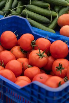 Fresh red tomatoes in boxes. Vegetables in local farmers market or supermarket. Rich harvest.