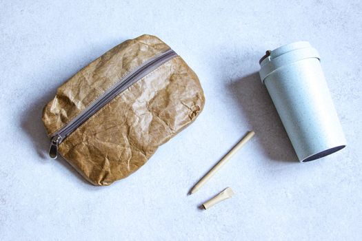 Pen, bag and cardboard cup made of recycled paper. Environmentally friendly stationary supplies. Eco friendly modern ecological biomaterials. Plastic pollution reduction concept. Zero waste concept.