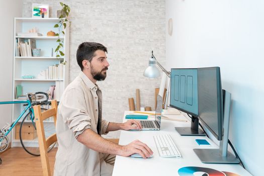 Freelancer working remotely from home. Millennial working on computer desk. High quality photo