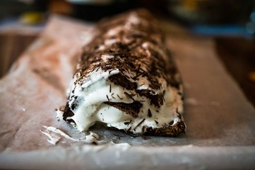 traditional Christmas dessert whole chocolate roll with cream, decorated with chocolate.