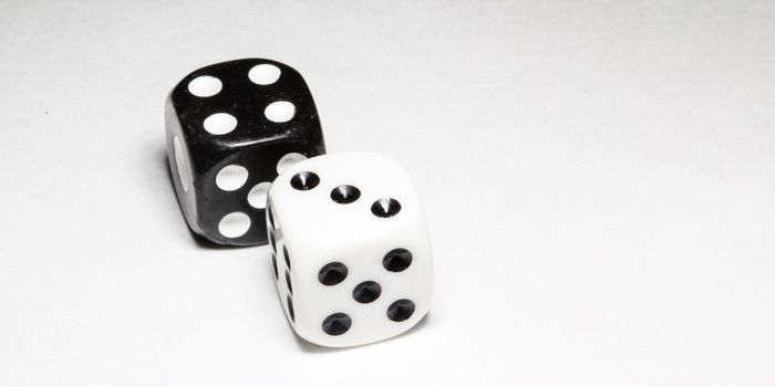 two white and black dices on a white background Win or lose Catch your luck Gambling equipment. High quality photo