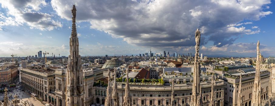 Milan, Italy. Panoramic aerial view from Duomo Cathedral terraces, terrazze del Duomo, with a dramatic sky.