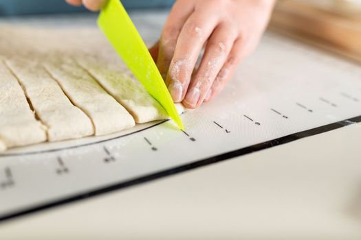 Close-up on process of cooking baking on a kitchen mat with markings, copy space.