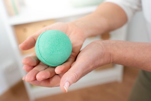 Closeup of a middle aged woman's hand with aromatic soap ball. Body care spa procedures anti-age recreation skin care, cosmetic and beauty concept.