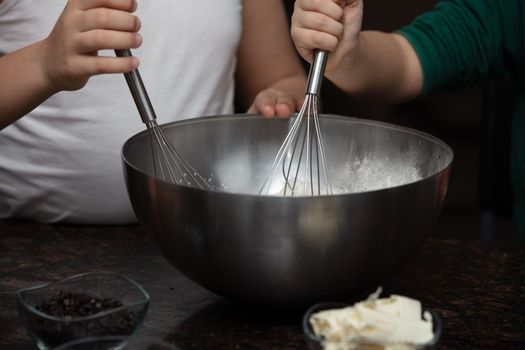 Kids baking cookies in house kitchen . Close-up child`s hands preparing cookies using cookie.