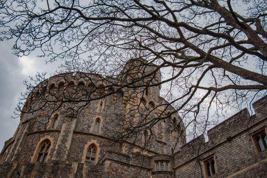 Windsor, UK, December 22nd 2022 - Tower at Windsor Castle with tree in foreground