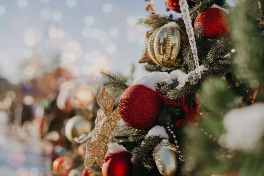 Close up of balls on christmas fir tree. Bokeh light garlands in background with copy space. Merry christmas and happy new year