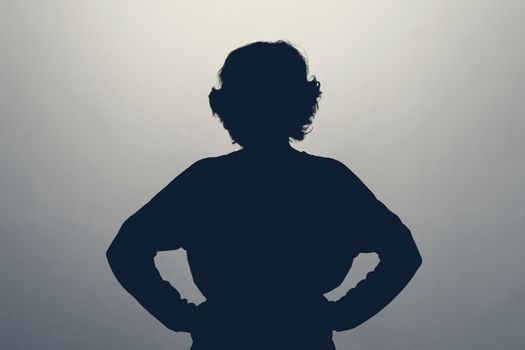Unknown female person silhouette in studio. Anonym, hide identity.