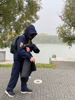 mysterious schoolboy walking with cold going back home.