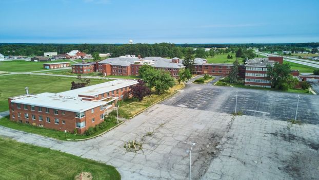 Image of Aerial over huge abandoned brick hospital in Indiana
