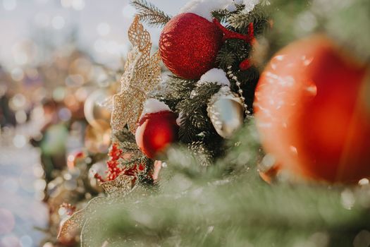 Close up of balls on christmas fir tree. Bokeh light garlands in background with copy space. Merry christmas and happy new year