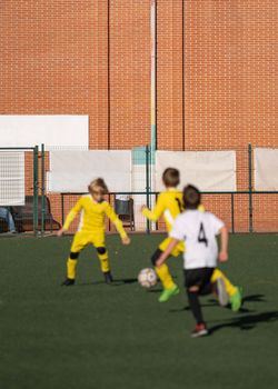 Subject defocused on purpose. Young Boys Play Soccer match on Grass Field. Football Tournament concept.