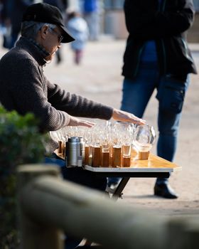 Street musician playing on a wine glass harp in Madrid , Spain.