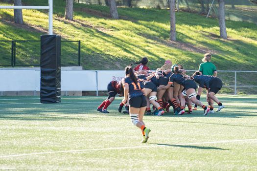 Tense moment of girls rugby fight . Dramatic challenging game for women's rugby team in match day.