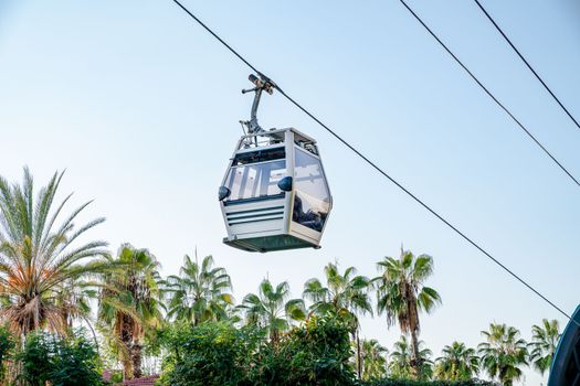 Funicular cab on background of sky and palm trees, close-up