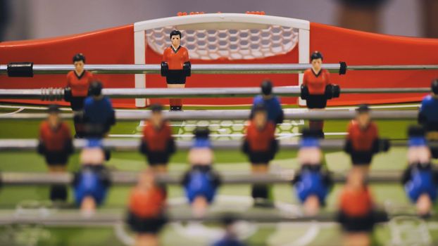 Players play table football in the clubhouse