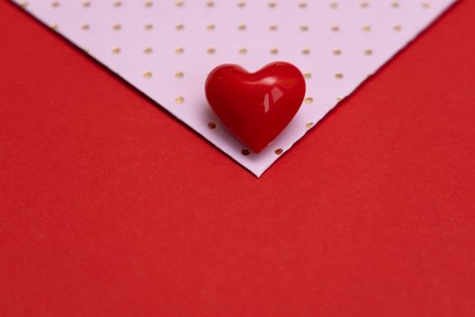 Valentines day red heart on same color background. Monochromatic vivid color. Valentine's day concept. Close up, copy space