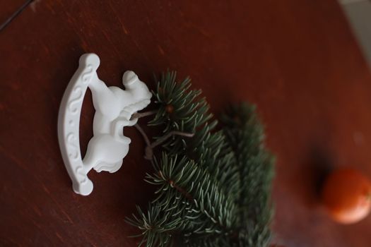 Christmas Toy horse, tangerines and pine cone. Winter holiday items for home decor. Flat lay stock photography.