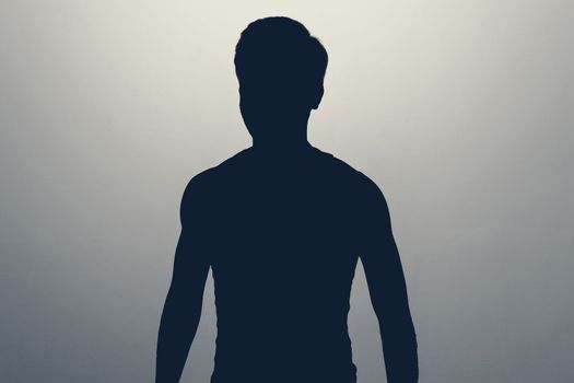 Unknown male person silhouette in studio. Concept of anonymous or hidden secret.