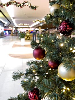 blurred decorated christmas tree in shopping mall background. High quality photo