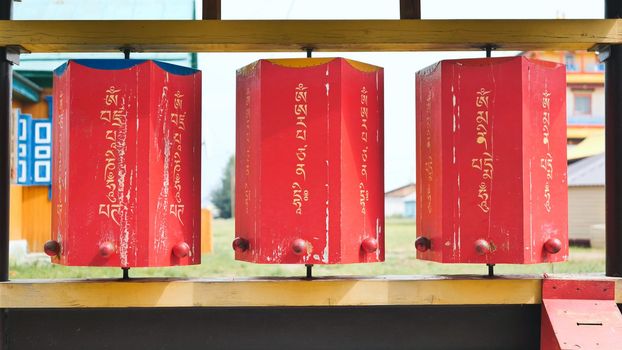 Rotation of the red prayer drums outside the Buddhist temple