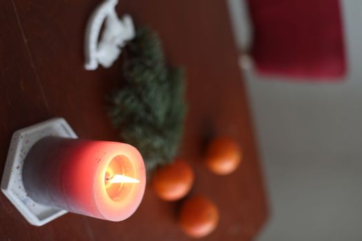 Christmas Toy horse, candle, tangerines and pine cone. Winter holiday items for home decor. Flat lay stock photography.