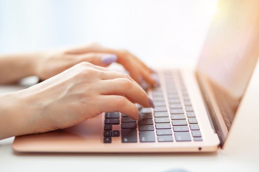 Purchases via the Internet and payment for services buy credit card. Hands type text and enter data on the laptop keyboard. An office worker checks his email while sitting at his desk