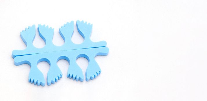 A pair of blue toe separators in the form of small feet, isolated on white background, Spongy material, copy space, High quality photo