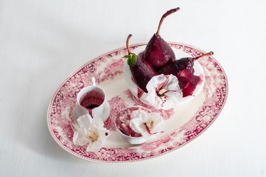 spicy pears cooked in red wine with vanilla ice cream on white dishes background, delicious summer still life and seasonal delicacies, gourmet sweet dessert, magenta color, High quality photo