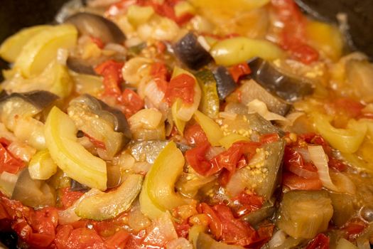 delicious juicy hot vegetable stew. ratatouille is cooked in a frying pan. High quality photo