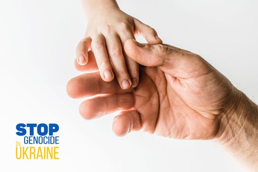 male hand hold children on white background with words stop genocide in ukraine. concept needs help and support, truth will win