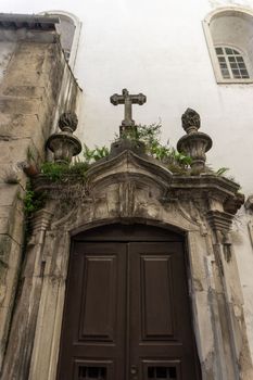 Black entrance to an old catholic church. Coimbra, Portugal