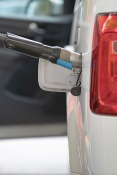 Fuel up the natural gas vehicle NGV at the station. Price increase concept.