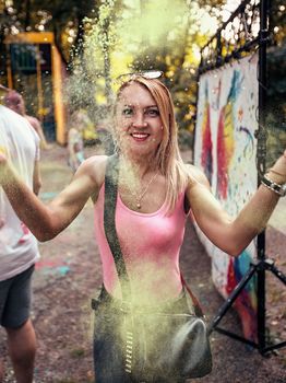 Young people, teenagers and adults celebrate the Holi event in Ukraine in Chernivtsi on March 8 in 2022. They have fun and throw paint at each other. High quality photo
