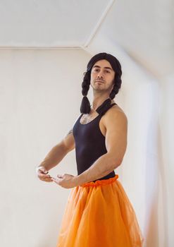 Young muscular man pretending to be a ballerina.