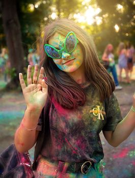 Young people, teenagers and adults celebrate the Holi event in Ukraine in Chernivtsi on March 8 in 2022. They have fun and throw paint at each other. High quality photo