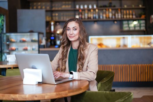 Business Woman Restaurant Owner Use Laptop In Hands Dressed Elegant Pantsuit Sitting Table In Restaurant With Bar Counter Background Caucasian Female Business Person Indoor