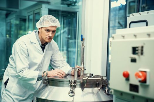 Portrait of a scientist, apothecary extracting cannabis oil using scientific equipment in a laboratory. Concept of cannabis extraction for alternative medicinal treatment. CBD oil extraction concept.