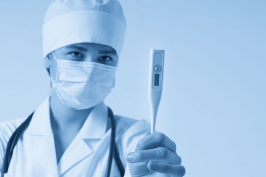 Young female doctor showing thermometer over white background with copy space