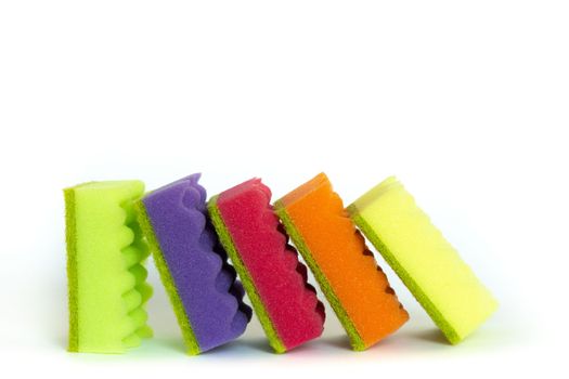 Stack of many multi-colored dish wash sponges isolated on white background. Household cleaning scrub pad.