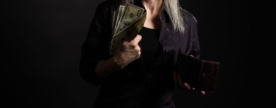 Young fun happy successful employee business woman 30s she wear casual brown classic jacket holding fan of cash money in dollar banknotes isolated on background studio portrait.