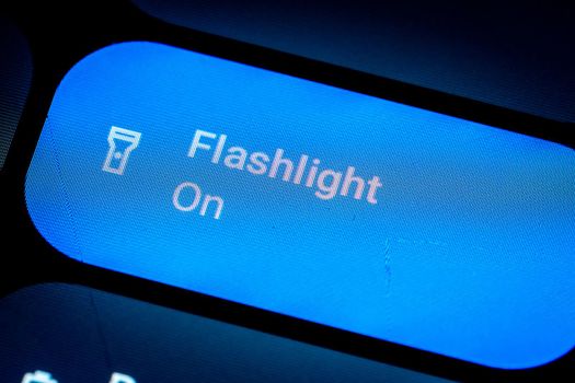 Close up of an Active button to enable the flashlight of an Android smartphone