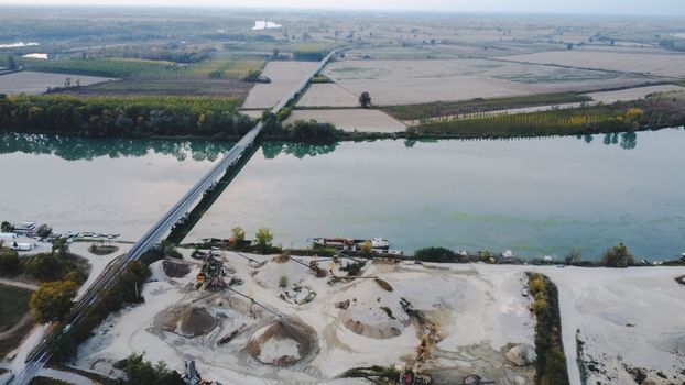 Top view of large manufacturing plant in landscape by the river Po, Piacenza Italy