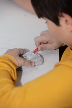 children's entertainment, a child plays in an archaeologist, children's hands dig dinosaur bones