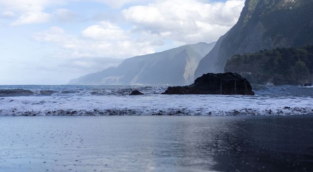 black sand beach of Madeira view on mountains. High quality photo