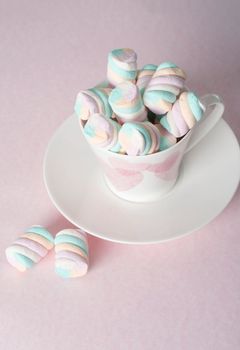 light pink and white marshmallows in a beautiful ceramic cups with pink hearts, Concept Mother's Day gift, Valentine's Day. High quality photo