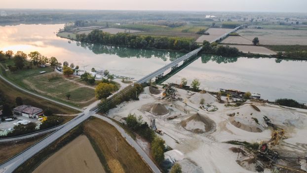 Top view of large manufacturing plant in landscape by the river Po, Piacenza Italy