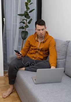 young man watching at laptop playing game. High quality photo