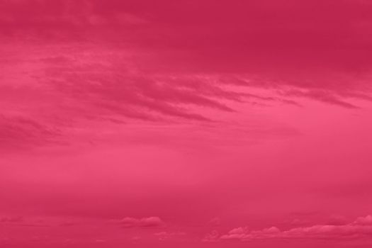 Viva Magenta dark cloudy background before the storm. Gloomy sky. Color of the year 2023. High quality photo.