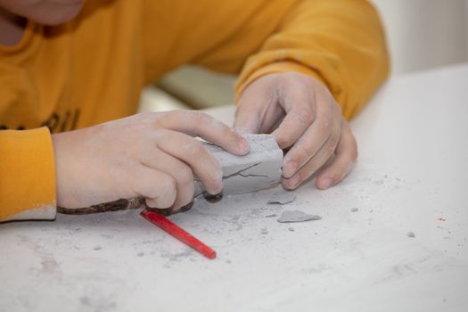 children's entertainment, a child plays in an archaeologist, children's hands dig dinosaur bones